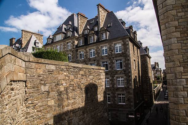 istock High-angle view overlooking a narrow, winding cobblestone street bordered by historic 2252097510