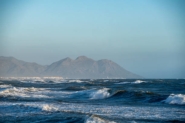 Waves hitting the shore of Austvagoy in the Lofoten archipel in Northern Norway during a beautiful winter afternoon.