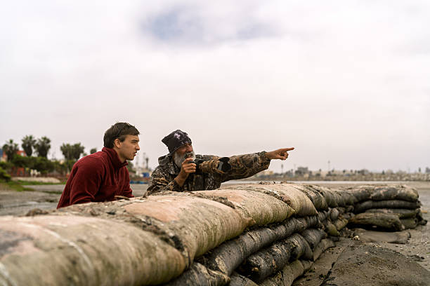 istock Men birdwatching, older man pointing out a bird 2252101737