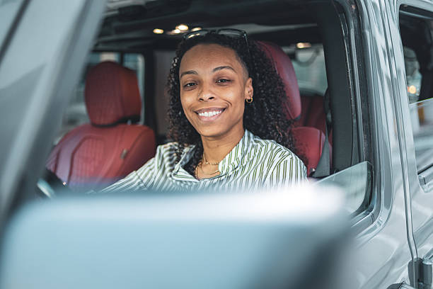 istock Smiling Woman Driving a Modern Car in an Urban Setting 2252104856