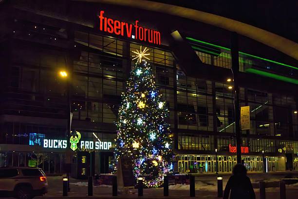 Milwaukee, Wisconsin, USA – December 13, 2025: On a cold December evening, a festive Christmas tree stands outside Fiserv Forum in Downtown Milwaukee, Wisconsin.