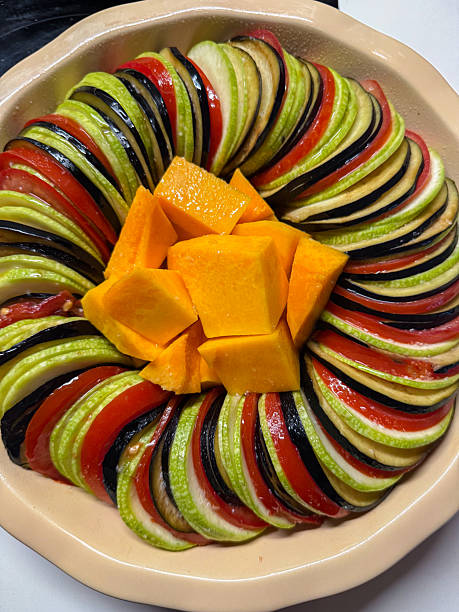 Healthy preparing colorful tian with fresh sliced vegetables