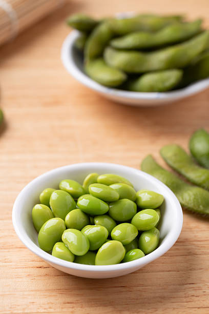istock Edamame beans (Japanese soybeans) in a bowl on wooden background 2252111732