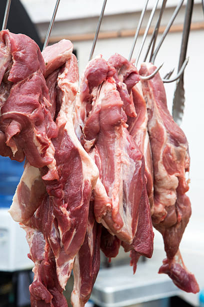 istock large pieces of raw meat hanging 2252113392