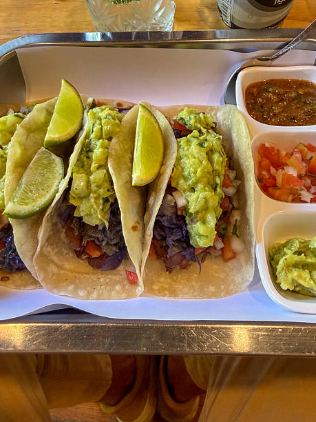 Three Vegan Soft Tacos with Guacamole and Lime Wedges
