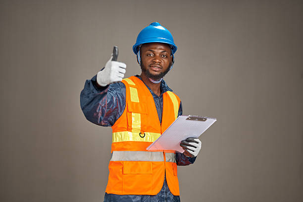 istock Young Nigerian construction worker giving thumbs up with clipboard 2252118537