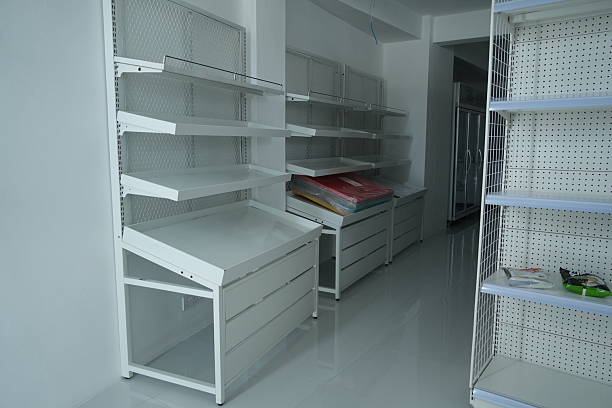 istock Empty white shelving units and display racks in a retail storage room 2252125934