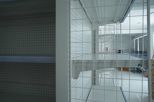 istock Empty retail store shelves with white grid panels and pegboard 2252125941
