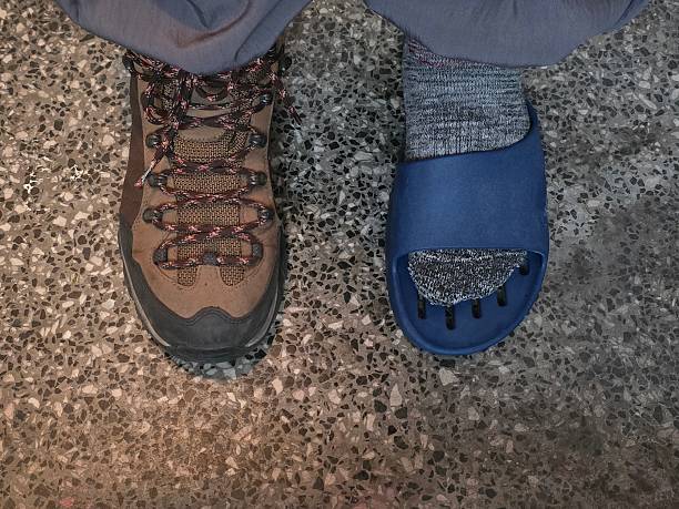 Is this a funny and interesting match composed of one hiking boot and one blue slide sandal? No! Acute and severe spasm caused by gout allows this odd combination on the way to a clinic.