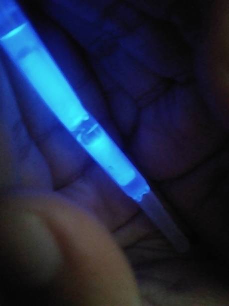 istock Electric Blue Glow Stick Held in Hand in Darkness 2252128818