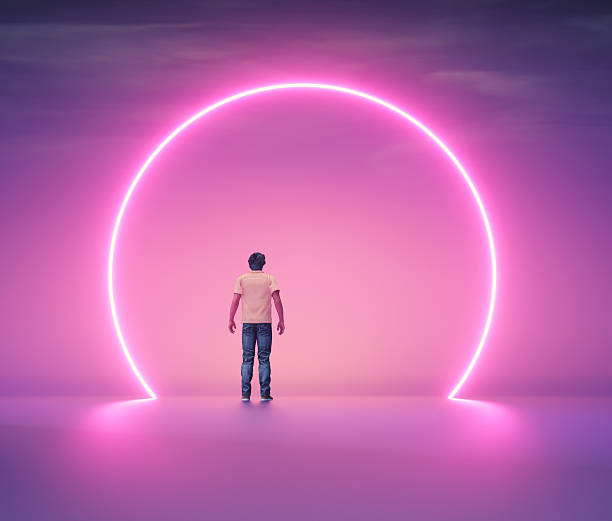 istock Man stands under glowing pink circle in a large empty space during twilight 2252132089