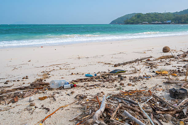 istock Plastic bottles and trash scattered on beach. 2252132844