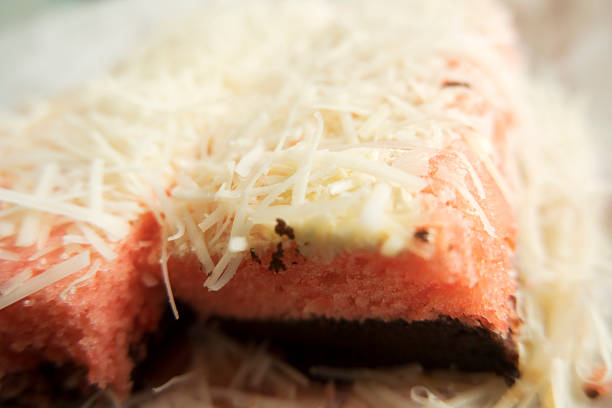 Pink Sponge Cake Slice with Cheese Topping Closeup