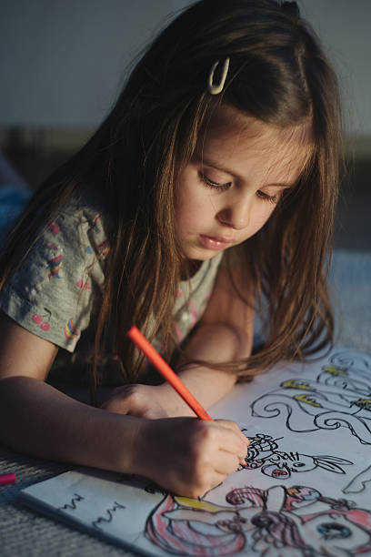 istock Girl Draws Diligently, Child Enthusiastically Colors Complex Pattern With Intense Focus And Care 2252133484
