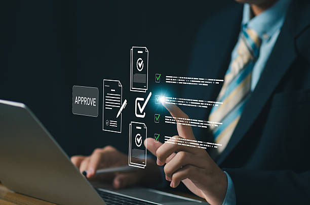 istock Business professional using laptop with digital approval checklist documents and check icons for quality assurance compliance workflow, data validation, audit control, and digital process management. 2252137679