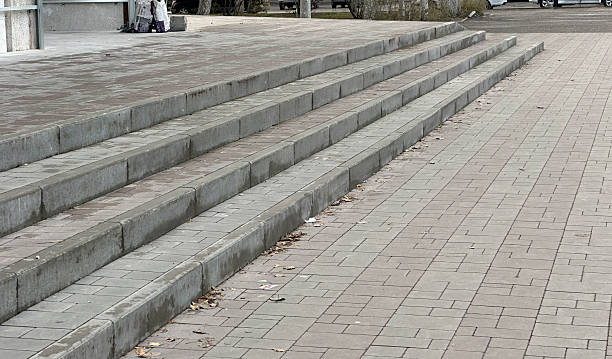 istock Steps connect ground level to an elevated area with a mostly clear path during the day 2252137843