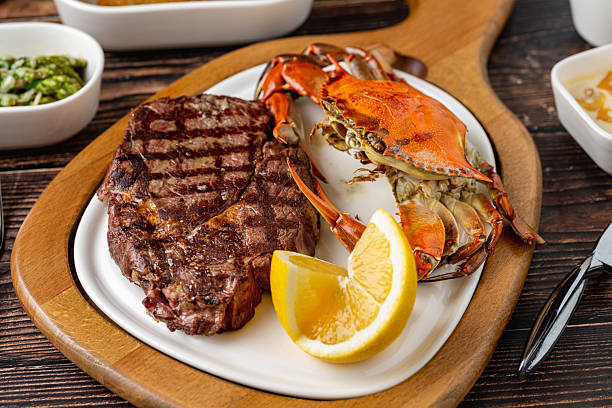istock Tenderloin steak served with whole crab and lemon wedge 2252138042