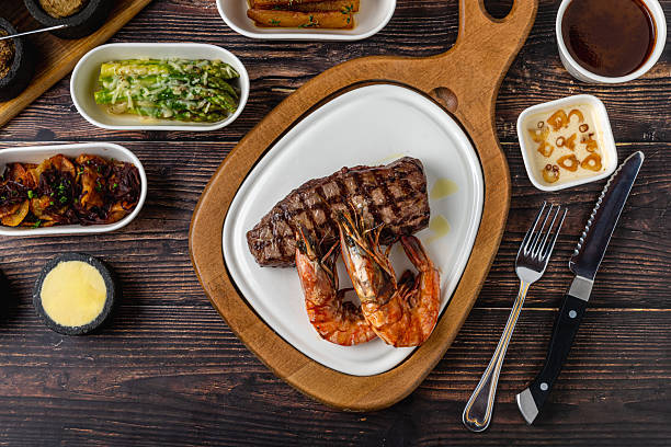 Tenderloin (bonfile) steak plated with large grilled prawns
