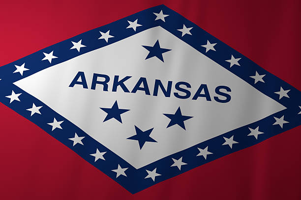 The official flag of Arkansas featuring a white diamond on a red background, bordered by blue with white stars and the state name in the center. The design symbolizes Arkansas as the only diamond-producing state in the U.S. and reflects its history, heritage, and statehood.