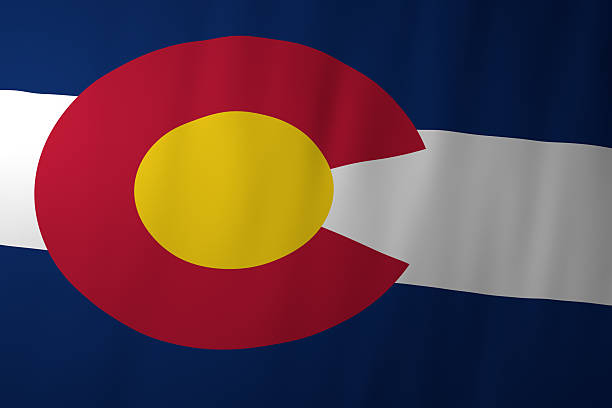 The official flag of Colorado featuring a bold red letter C with a golden circle on a blue and white striped background. The design symbolizes the state’s name, sunshine, and scenic landscape, including its mountains and clear skies.
