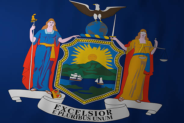 The official flag of New York featuring a deep blue background and the state coat of arms with two allegorical female figures representing Liberty and Justice, a shield with a sunrise over mountains and water, and the motto “Excelsior.”