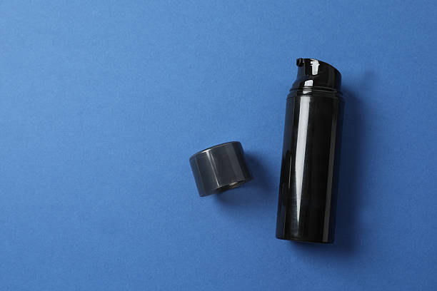 istock Black cosmetic bottle on color background 2252140549