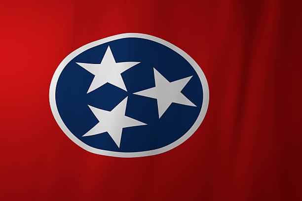 The official flag of Tennessee featuring three white stars within a blue circle on a red background. The design represents the three Grand Divisions of the state and symbolizes unity and heritage.