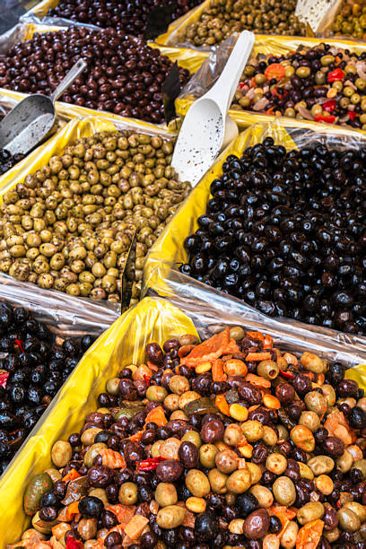 istock Marinated olives in containers at a stall 2252140636