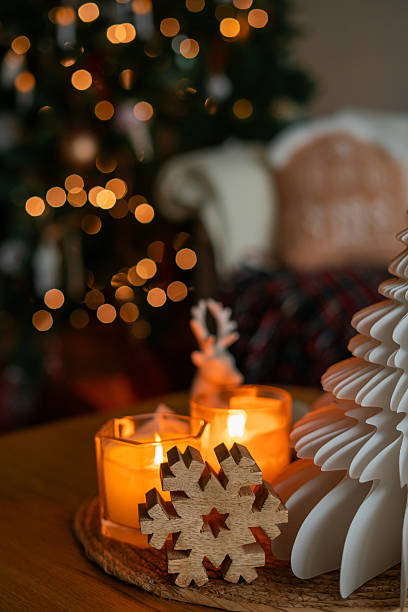 Festive home decor. Christmas tree, burning candles. New Year. Winter.