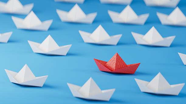 istock Different business concept.new ideas. paper art style. creative idea. red leader boat, standing out from the crowd of white boats.3D rendering on blue background. 2252153276