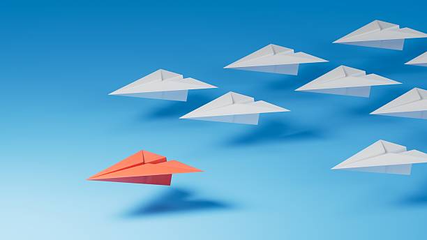 istock Leaderplane concept. Red leader paper plane leading among white on blue background. copy space.3D rendering on blue background. 2252153291