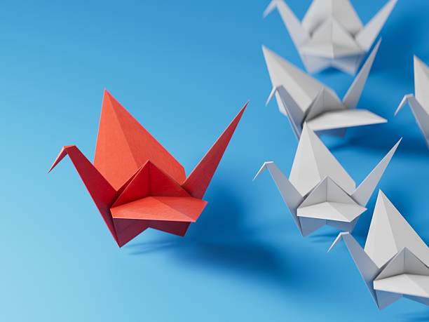 istock Different business concept.new ideas. paper art style. creative idea.red leader swan, standing out from the crowd of white swans.3D rendering on blue background. 2252153321