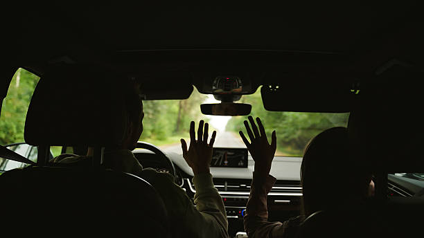 istock Father and daughter joyfully singing and dancing together inside a car 2252156209