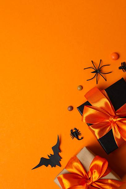 istock Happy Halloween holiday concept. Festive background design featuring gift boxes, bats, pumpkins, spiders and confetti. 2252157145