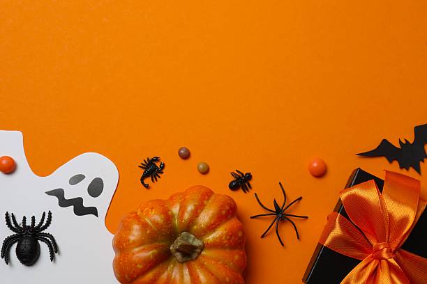 istock Halloween flat lay composition with ghosts, pumpkin, bats, spiders and confetti. Happy Halloween holiday concept. Top view 2252157155