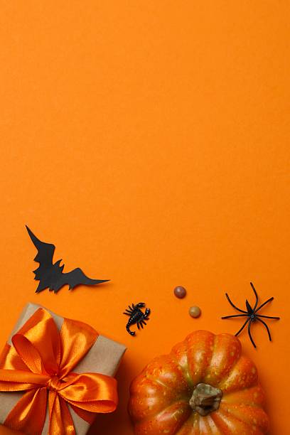 istock Happy Halloween holiday concept. Festive background design featuring gift boxes, bats, pumpkins, spiders and confetti. 2252157159