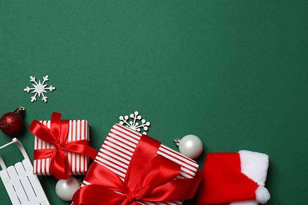 istock Beautiful gift boxes tied with bows and Christmas decorations on green background 2252157246
