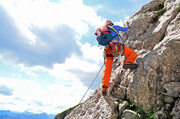 She is reaching up to hand while climbing