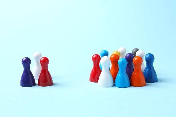 istock Group of colored pawns on a blue table. Concept of unity 2252158014