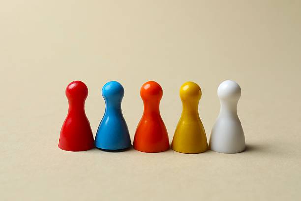istock Group of pawns on the table. Concept of unity 2252158073