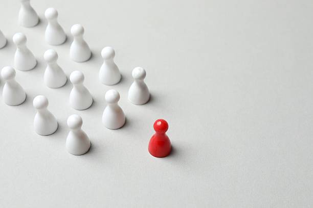 istock Group of pawns on a light background 2252158096