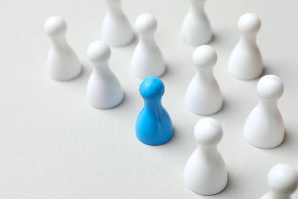 istock Group of pawns on a light background 2252158097