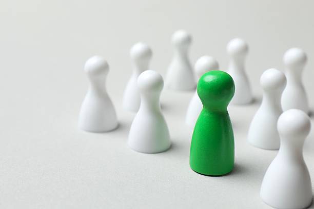 istock Group of pawns on a light background 2252158098