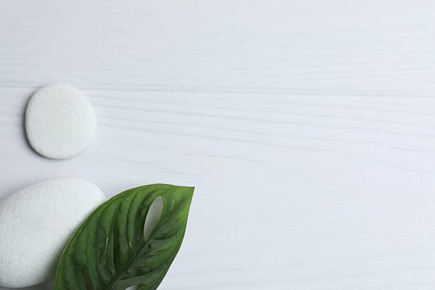 istock Spa concept. Composition with symbolic objects for spa salon. Stones with green leaf representing balance. Close up, copy space, top view, background 2252160031