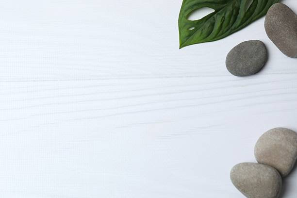 istock Spa concept. Composition with symbolic objects for spa salon. Stones with green leaf representing balance. Close up, copy space, top view, background 2252160038