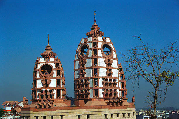 Front view of Ancient Hindu temple exterior from amidst trees located in a small city of Haryana state India.