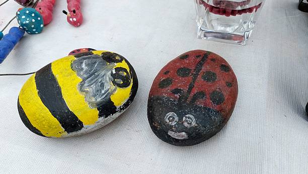 istock Hand Painted Decorative Stones Featuring Bumblebee Ladybug Designs 2252167295