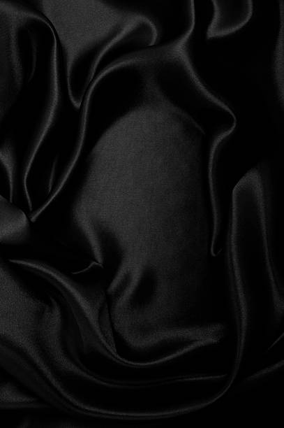 istock Smooth elegant black silk or satin luxury cloth texture as abstract background. Luxurious background design 2252167367