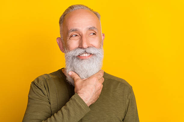 istock Photo of pretty dreamy mature man dressed khaki pullover arm chin looking empty space isolated yellow color background 2252168615