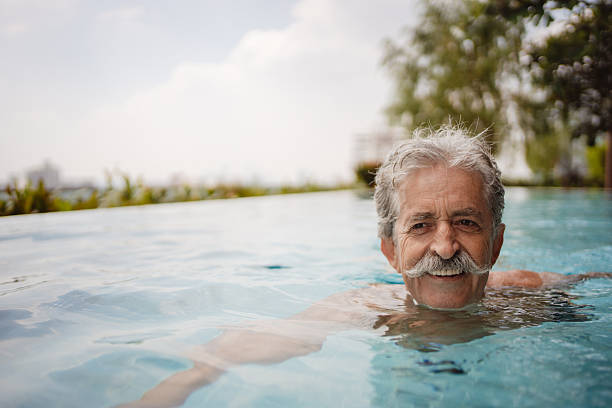 istock Senior man swimming  in a pool 2252169097